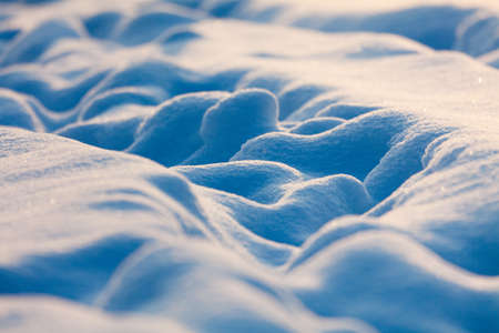 Pathway among the snow drifts in the evening lightの写真素材