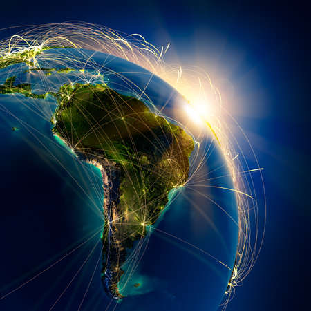 Highly detailed planet Earth at night, lit by the rising sun, with embossed continents, illuminated by light of cities, translucent and reflective ocean. Earth is surrounded by a luminous network, representing the major air routes based on real dataの写真素材