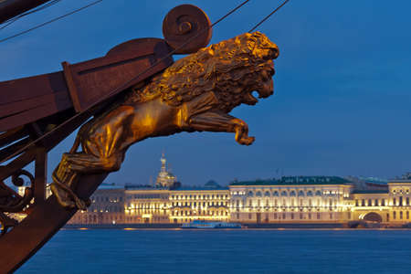 View of the Palace Embankment  In the foreground, a decorative sculpture of a lion on the bow of sailing ship  Twilight, white night  St  Petersburg  Russiaの写真素材