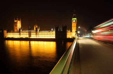 Big Ben, London at night time with Red Bus travelling by...の写真素材