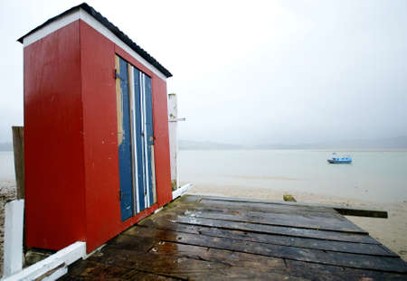 Old red boat shed on the coastの写真素材