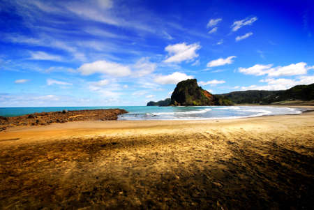 Early morning beach scene with sailboat in foregroundの写真素材