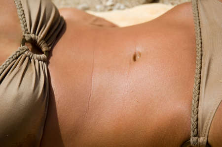 Toned torso of a tanned femaleの写真素材