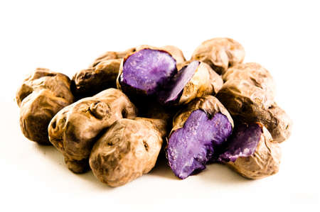 Collection of purple potatoes on white backgroundの写真素材