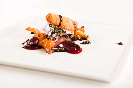 beef with mushrooms and beetroot on white plateの写真素材