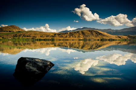 Panoramic landscape view of mountain lake and clear blue sky.の写真素材