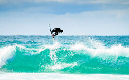 Surfing in nice  weather with great waves and blue skyline.の写真素材