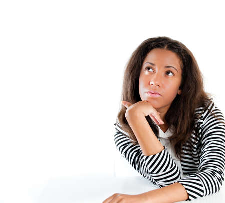 beautiful mixed race teen girl, with hand resting on chin, thinking  の写真素材
