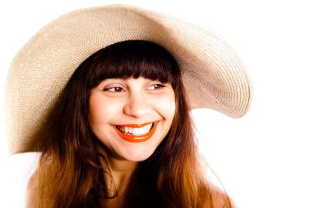 Closeup of young beautiful woman wearing a straw hat, giving you a warm smile, with teeth and red lipstickの写真素材