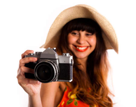 Young woman with old camera, taking photos, wearing a straw hat, giving you a warm smile,の写真素材