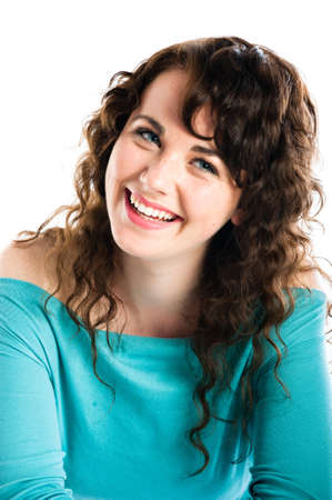 Beautiful smiling teenage girl wearing turquoise, smiling with head slightly tiltedの写真素材
