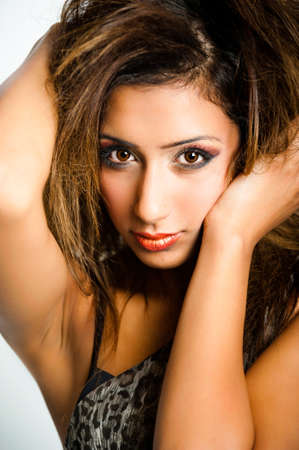 Close-up of portrait of fresh beautiful young Asian fashion model hand in hairの写真素材