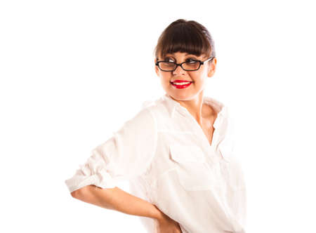 Beautiful young business woman in white, with glasses and red lips with hand on waist の写真素材