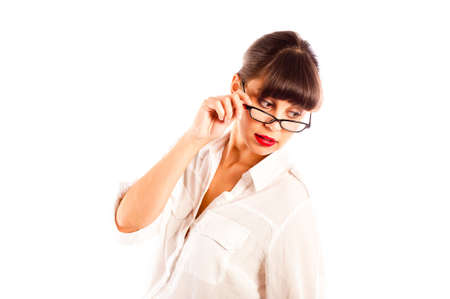 Beautiful young business woman in white, tilting glasses and red lips looking downの写真素材
