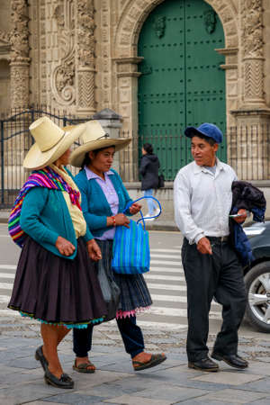 Cajamarca, Cajamarca/Peru - 16.12.2019: Peruvian locals walking on the sidewalk in front of the main city cathedralのeditorial素材