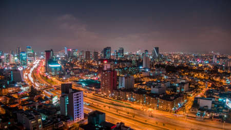 Lima, Peru - 13.08.2019 - Panoramic aerial night view over Via Expresa highway and the business...