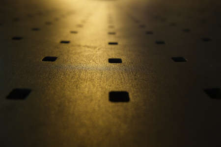 Abstract look of metal bench with yellow night lightの写真素材
