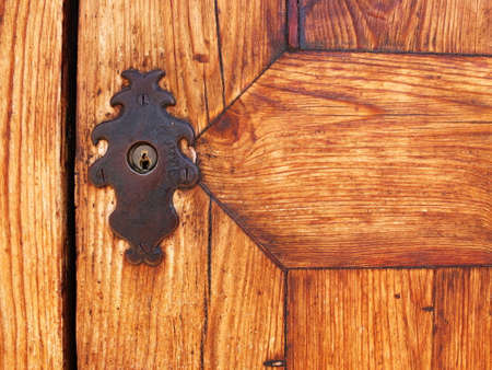 Wooden gate doors with ancient iron lockerの写真素材