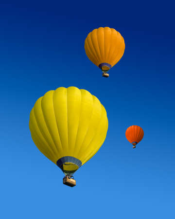 Three hot air balloons flying on dark blue sky backgroundの写真素材