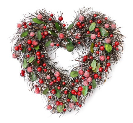 Heart shaped Christmas garland with red berries and green leaves on white backgroundの写真素材