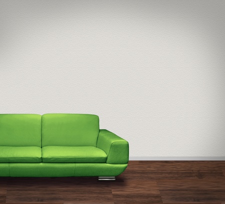 Modern green leather sofa in room with dark floor and white wallsの写真素材
