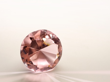 Topaz gemstone diamond shining on light pink backgroundの写真素材