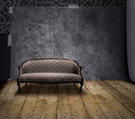 Antique sofa in rough patina wall and old wooden floor roomの写真素材