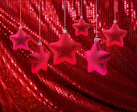 Red Christmas decoration stars hanging on red glitter canvasの写真素材