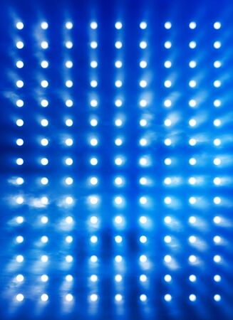 Rock stage spotlights background blurred by blue smoke effectの写真素材