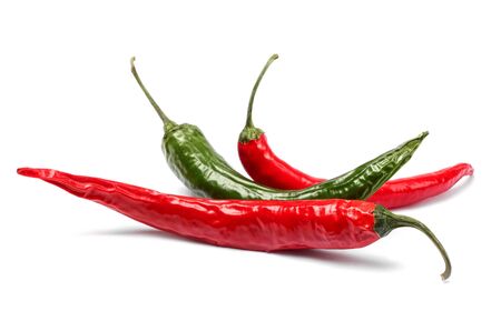 Red and green chili peppers isolated on whiteの写真素材