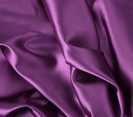 Wavy folded luxury shiny satin silk backgroundの写真素材