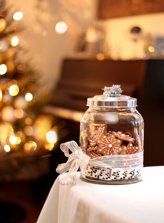 Homemade Christmas gingerbread biscuits in glass jar on tableの写真素材
