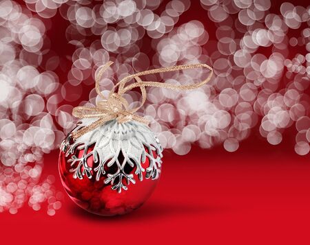 Christmas ball with snowflake decoration, red bokeh backgroundの写真素材