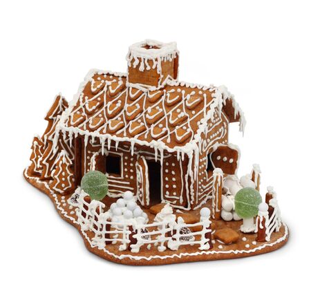 Homemade gingerbread house cottage isolated on whiteの写真素材