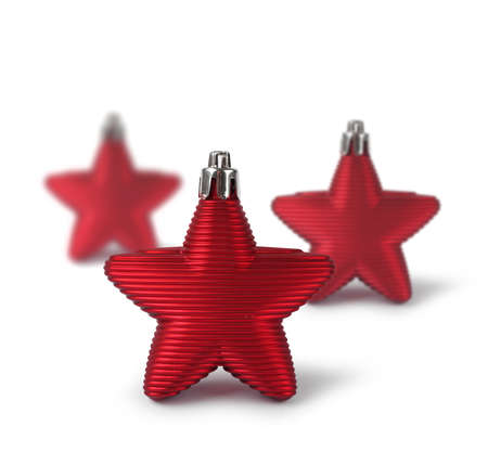 Three red Christmas decoration stars isolated on white backgroundの写真素材