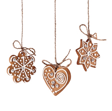 Christmas gingerbreads hanging in traditional linen string isolatedの写真素材
