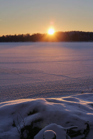 Sunset on frozen lake, winter season conceptの写真素材