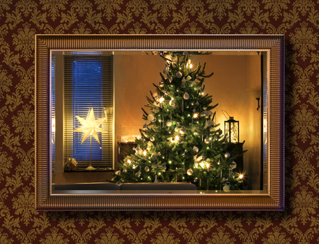 Illuminated Christmas tree seen through wall mirrorの写真素材