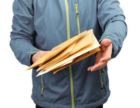 Male courier service worker or postman delivering letters
