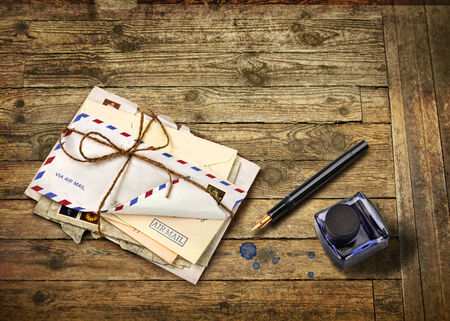 Nostalgic airmail letters with ink bottle and fountain penの写真素材