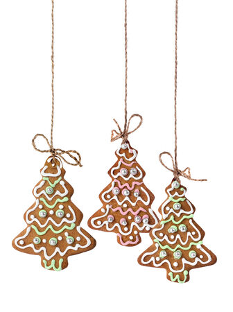 Christmas tree cookies hanging on a natural linen ribbonの写真素材