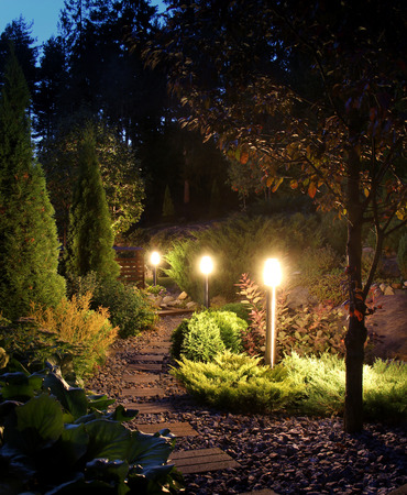 Illuminated home garden path patio lights in evening duskの写真素材