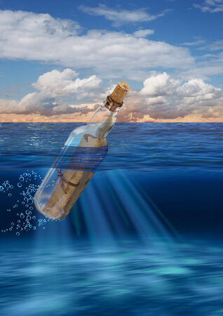 Message in bottle floating on open seaの写真素材