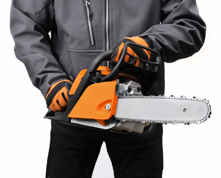 Male worker holding new chain saw isolated on whiteの写真素材