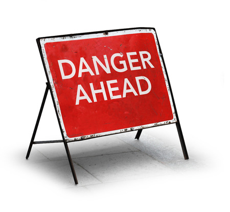 Grungy road sign danger ahead isolated on white backgroundの写真素材