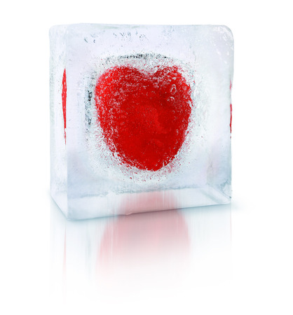 Red heart frozen inside an transparent ice cube blockの写真素材