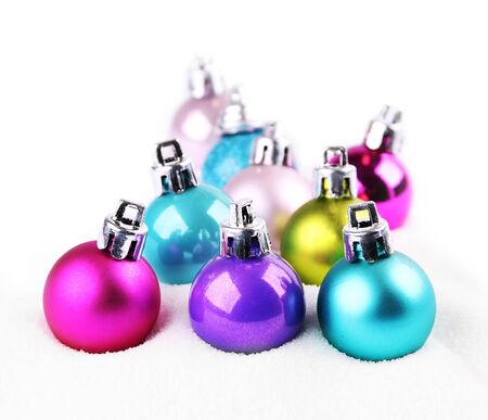 Colorful Christmas balls in snow, shallow DOFの写真素材