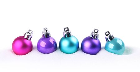 Colorful Christmas balls in snow isolated on whiteの写真素材