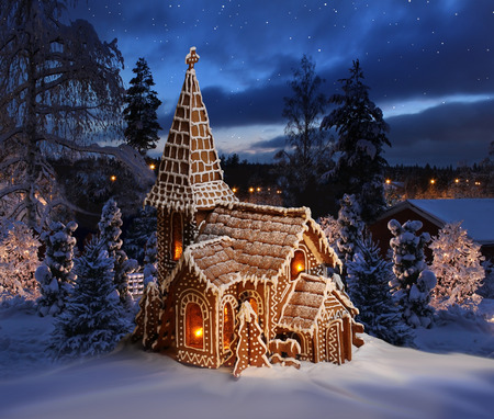 Gingerbread church on snowy Christmas nightの写真素材