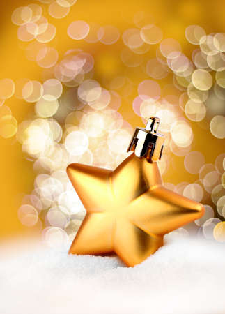 Golden Christmas decoration star on bokeh backgroundの写真素材